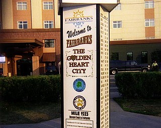 A park in Fairbanks, Alaska, has a marker indicating the distance to surrounding cities in miles and kilometers.