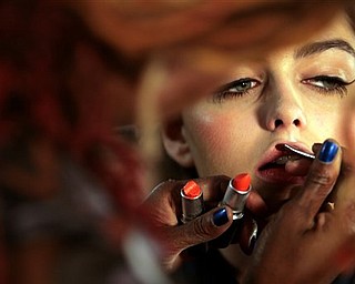 Sonia Watson designs the look for model Darla Baker backstage, as she prepares to model the Nanette Lepore 2008 spring collection, during Fashion Week in New York, Monday Sept. 10, 2007.