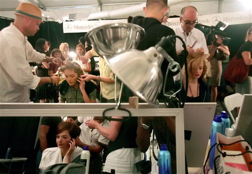 Models sit backstage for make up artists who design their looks, as they prepare to model the Nanette Lepore 2008 spring collection during Fashion Week in New York, Monday Sept. 10, 2007.
