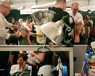 Models sit backstage for make up artists who design their looks, as they prepare to model the Nanette Lepore 2008 spring collection during Fashion Week in New York, Monday Sept. 10, 2007.