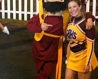 The South Range Raider mascot finds senior cheerleader, Mandie Custer
hanging out on the sidelines.