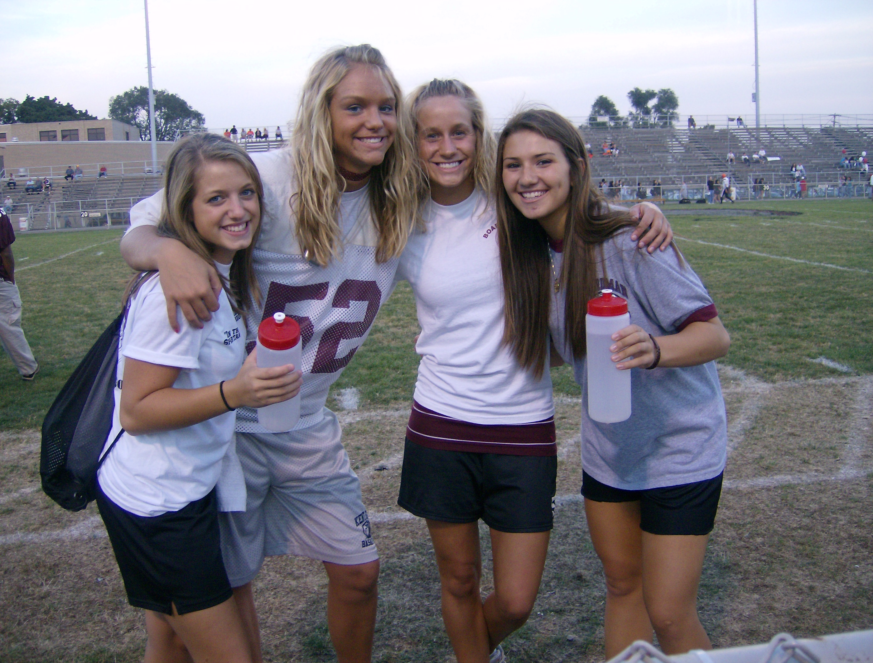 Spartan trainers Courtney Ivan, Courtney Schiffauer, Melanie Sfara, and Monica Touvelle, who all play sports, help out the Football team by filling up the water bottles before the big game.
