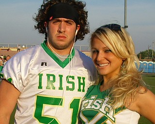 Ursuline Football Captain, Ryan Kelly and Cheerleading Captain,
Katie Olenick, prepare for the game.