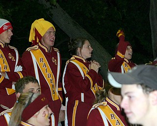 Patrick McLaughlin shows his school spirit with a bold Burgundy and
Gold hat as he cheers with his friends Matt Venesky, Diana Rhodes, and
Devon Parks.