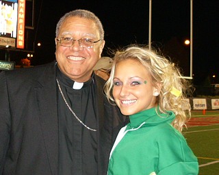 Ursuline Cheerleading Captain Katie Olenick poses with the wonderful Bishop Murry at the Ursuline vs. Mooney game!