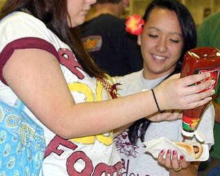 "Katie Chadwick helps Loke Kalima with ketchup at the tailgate pep
rally at South Range."   (BTW, the pep rally was scheduled outside
until the bank robbery in North Lima kept everything inside!!)
