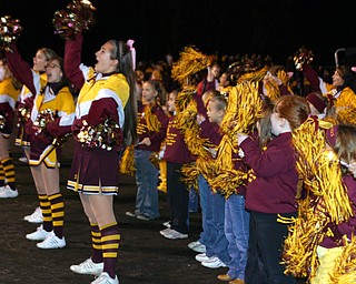 "South Range cheerleaders are helped by the elementary cheerleaders on
the sideline for the last regular season."