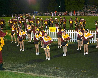 "The South Range Raider mascot looks on as the cheerleaders cheer for VICTORY!"