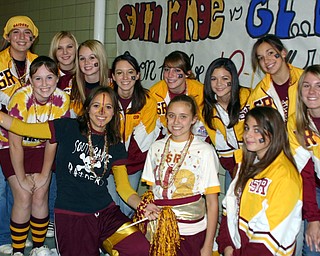 "Meaghan Beachley, with pom-poms, wins the "lunch time spirit
walk-off" and is surrounded by well-wishers."