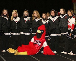 Canfield varsity cheerleaders take time to pose with their Cardinal mascot.