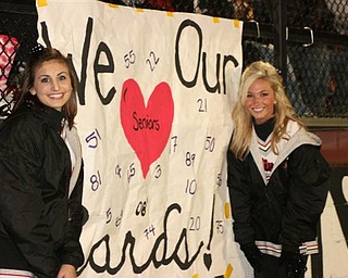 Seniors Allison Queen and Kaitlyn Brogley show their Cardinal pride with a
sign they made.