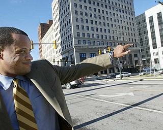 MAYORAL SUPPORT: Mayor Jay Williams waves to a passerby in downtown Youngstown. Williams calls the headway made by the city’s demolition crews in demolishing vacant and abandoned buildings one of the most tangible successes to date.