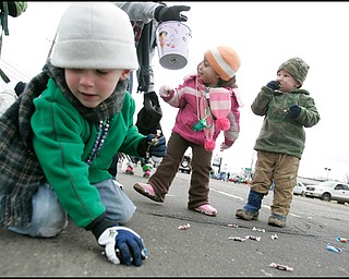 3.16.2008
Liam Cassidy (4) (left) of Coitsville, grabs candy off the pavement as Olivia Rouser (2) (center), of Canfield, and Conner Wills (2) (right), also of Canfield munch on their findings during The 30th Annual Mahoning Valley St. Patrick’s Day Parade in Boardman.
