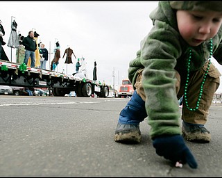 3.16.2008
Connor Wills (2), of Canfield, picks up a piece of candy as the floats roll past during The 30th Annual Mahoning Valley St. Patrick’s Day Parade in Boardman.

