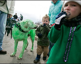 3.16.2008
Liam Cassidy (4) (right), of Coitsville, and Conner Wills (2) (center), of Canfield, eat treats alongside Eli, the Cassidy family dog during The 30th Annual Mahoning Valley St. Patrick’s Day Parade in Boardman.

