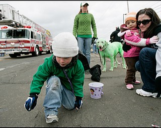 3.16.2008
Liam Cassidy (4), of Coitsville, collects candy along side Olivia Rouser (2) and her mother, Renee Rouser, both of Canfield, and his own mother, Shawnee Cassidy and their dog Eli during The 30th Annual Mahoning Valley St. Patrick’s Day Parade in Boardman.


