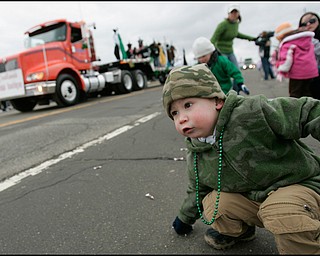 3.16.2008
Conner Wills (2), of Canfield picks up candy thrown by the participants of The 30th Annual Mahoning Valley St. Patrick’s Day Parade in Boardman.