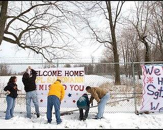 3.22.2008
Family and friends show their support for 23 marines, returning from a seven month deployment in Iraq, at the Youngstown Air Reserve Station in Vienna Saturday afternoon.