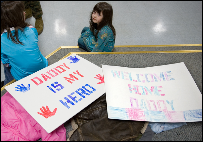 3.22.2008
Liliana Norris, age 5 of Hermitage, sits beside signs made in anticipation of her father's return from a seven month deployment in Iraq at the Youngstown Air Reserve Station in Vienna.
