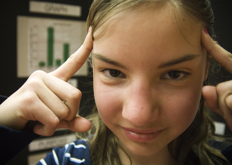 12-year-old Nicole Zielinski attempts to start a fire with her mind. The St. Joe's of Austintown student presented her findings on the strengths of different brands of paper towel at the science fair on Saturday. 