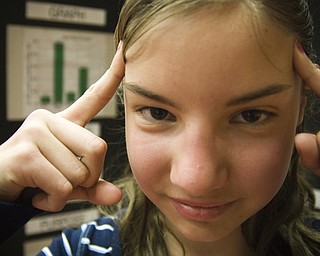 12-year-old Nicole Zielinski attempts to start a fire with her mind. The St. Joe's of Austintown student presented her findings on the strengths of different brands of paper towel at the science fair on Saturday.