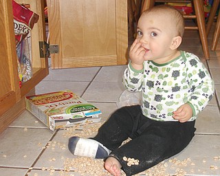 SNACK TIME: Anthony John Tabak, 1, helping himself to a little snack. Son of John and Lisa Tabak, Jr. of Austintown. Submitted by Lisa Tabak.