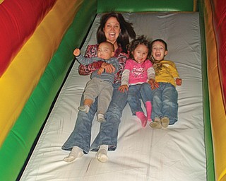 Lisa Tabak of Austintown having a little fun with the kids, from left, Anthony Tabak, 1; Candace Ackworth, 21 months; and Brandon Tabak, 4 1/2, at Jump Around in Boardman. The other parents are John Tabak Jr. and mark and Michele Ackworth.