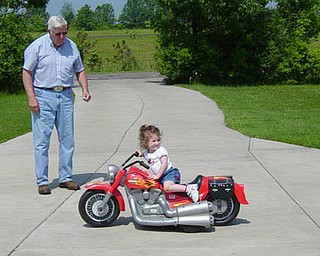 Jill Moran's daughter, Madelyn, 3, takes charge of her "motorcycle."