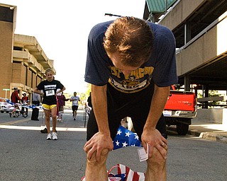Amun Rigstad, 34, of Youngstown takes a deep breath after finishing the race in just over 32 minutes. With over 300 people in attendance, the finish line at the YMCA's annual five-mile run offered a look at the people who jog these valley walls.
