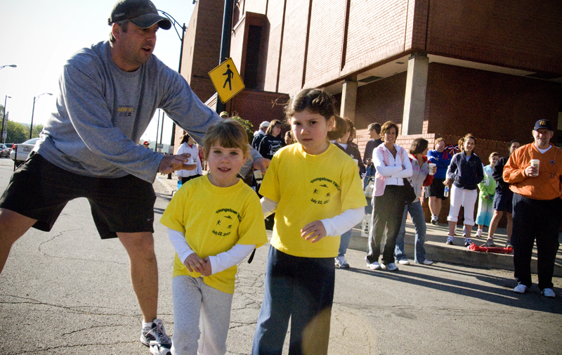 Elizabeth Galla, 6, and her sister Lillian, 4, of Poland needed a gentle push from their father, Bill, to start running. 