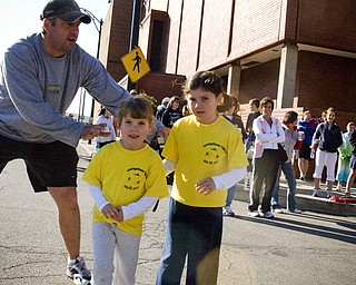 Elizabeth Galla, 6, and her sister Lillian, 4, of Poland needed a gentle push from their father, Bill, to start running.