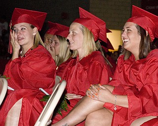 Diplomas were followed by a slide show made of snaps-shots from graduates' family photo albums. Melissa Eggleston, left, cried. Jessica Ferrick, right, laughed. In the center, Candice Fair, remained calm.