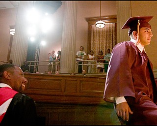 6.1.2008
Thair Mahmud Farah walks up to the stage to receive his diploma during Liberty High School's commencement at Stambaugh Auditorium Sunday afternoon.
