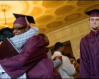6.1.2008
Nathaneil Byrd III. stops for a hug as Adam Carpenter and his fellow graduating seniors from Liberty High School exit Stambaugh Auditorium Sunday afternoon.