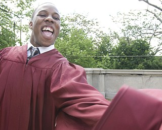 Taylor Hill, 18, of Youngstown, celebrates completion of four years of high school on a landing outside Stambaugh Auditorium.
