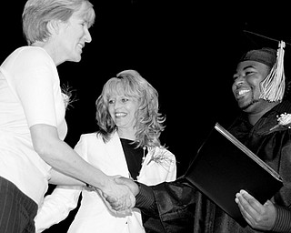 L-R School board Member Shari Harrell, Principal Ruth E. Zitnik and Graduate LaMar Coleman.