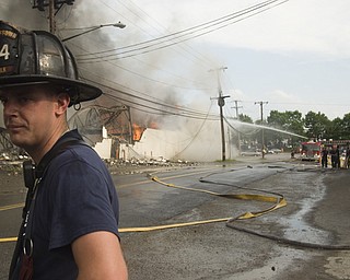 Fireman Daniel Holcomb, 28, of Youngstown two hours into battling the flea market fire.