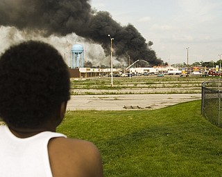 More than a mile away, Leon Bell, 10, of Youngstown watches the building's incineration.