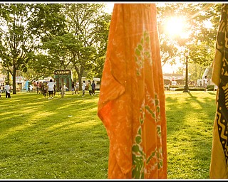 Two pieces of traditional West African clothing hanging in Courthouse Square for sale.