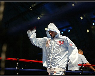 Hooded, Kelly Pavlik enters the ring. 