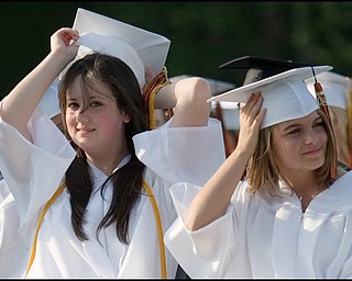6.8.2008
Mara Boyce (left) puts her cap back on after it blows away during Springfield High School's Class of 2008 commencement ceremony Sunday evening at the school's stadium.