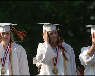 6.8.2008
Katherine Phillips, Katlin Potochnik and Noelle Bruno hold onto their hats as the wind blows during Springfield High School's commencement ceremony held Sunday evening at the school's Stadium.