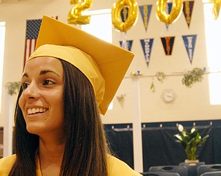 Last to leave, Lowellville graduate Whitney Palumbo, a National Honor Society inductee, poses for a picture under giant inflatable numbers.