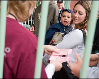 6.17.2008
Monica Rose and her son, Gavin, of West Middlesex, enter the game while her husband hands over the tickets at the Mahoning Valley Scrappers' season opener at East Wood Field, Tuesday evening.