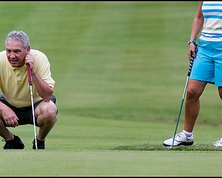 6.24.2008
John Finizio, of Poland plans out his shot before putting on the second green of the DeBartolo Golf outing at the Youngstown Country Club, Tuesday morning.