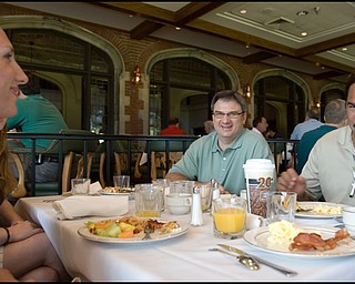 6.24.2008
Dan Deafino (right), Curt Peschae (center), and Jessica Mollally (left), all from Cleveland, eat breakfast before hitting the course for the DeBartolo Golf outing at the Youngstown Country Club, Tuesday morning.