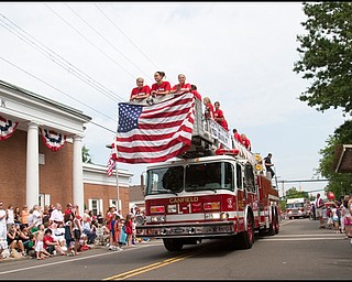7.4.2008
Canfield's State Championship winning High School Girls Varsity Softball Team rides atop a fire truck along Route 46 during Canfield's Fourth of July parade Friday morning.