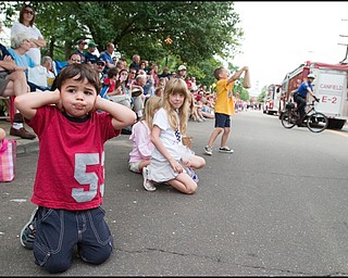 7.4.2008
Caleb Dean (2), of Austintown, takes a break from scavenging candy to cover his ears as fire trucks drive past blaring their sirens during the Fourth of July Parade in Canfield, Friday morning.