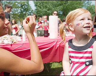 7.4.2008
Ceara Carney, a Canfield High School Cheerleader and junior classman, paints Macey Kalina's, (age 3 of Canfield) name on her cheek opposite a firecracker during Canfield's Fourth of July Parade, Friday morning.
