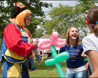 7.4.2008
George Caban, of Campbell, a.k.a. "Porgie the Clown" cracks jokes while making a purple teddy bear balloon animal for Kaylee Kilbert (12), of Canfield, following Canfield's Fourth of July Parade in downtown Canfield, Friday morning.